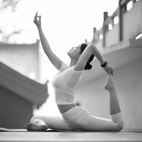 Person meditating peacefully in a natural outdoor setting.
